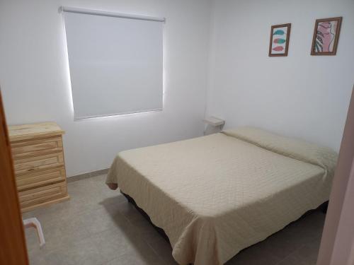 En eller flere senge i et værelse på Departamentos TUNQUELEN