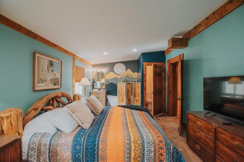 a bedroom with a large bed and a television at 3 King Beds Hot Tub Arcades 5 Baths in Albuquerque