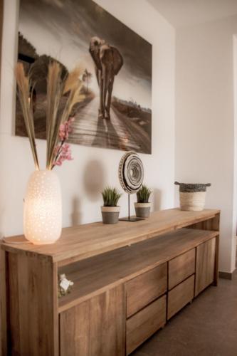 a wooden cabinet with plants on it in a room at Résidence Alissa Charleroi Airport in Charleroi