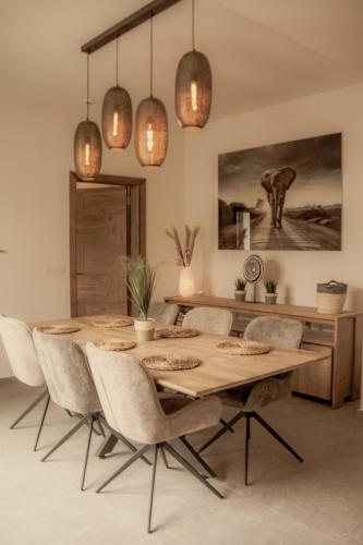 a dining room with a wooden table and chairs at Résidence Alissa Charleroi Airport in Charleroi