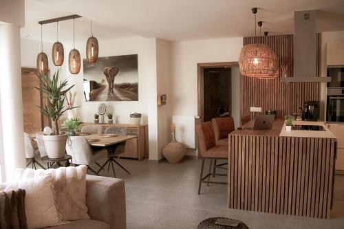 a living room and kitchen with a couch and a table at Résidence Alissa Charleroi Airport in Charleroi