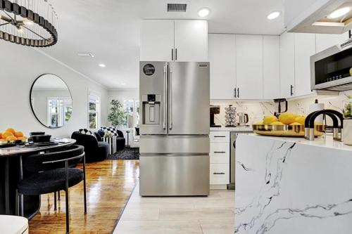 a kitchen with a stainless steel refrigerator in a room at Casita Lake Worth - BEACH LIFE! in Lake Worth