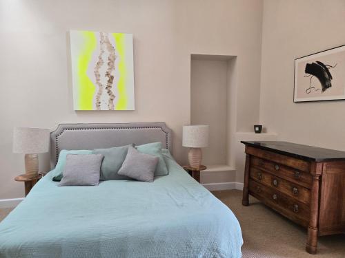 a bedroom with a bed and a wooden dresser at Bastide du Luberon in Apt