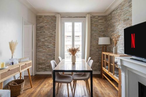 une salle à manger avec une table et des chaises dans l'établissement Le Théophile - 25 min from Paris, à Le Raincy