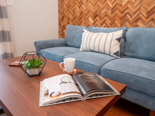 a coffee table with a book and a cup of coffee at Jennifer's Walkable Private Apartment Getaway with Relaxing Deck in Providence