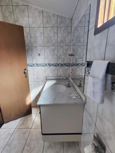 a bathroom with a sink and a mirror at POUSADA FLOR DE LIS in Diamantina