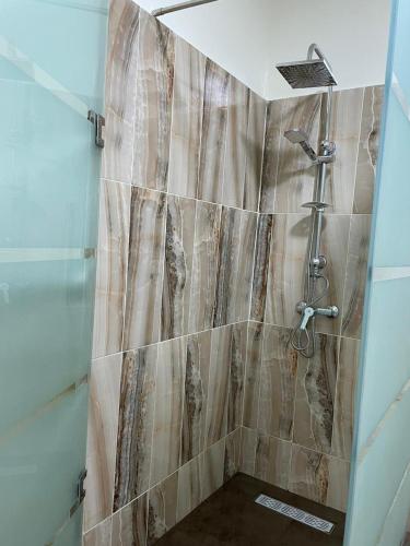 a bathroom with a shower with a glass door at Kawtar in Pont Blondin