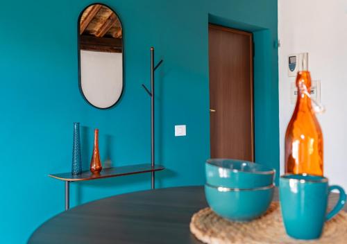 a table with a bottle and a bowl on it at Roma 20min-Elegante Loft Storico Grottaferrata in Grottaferrata