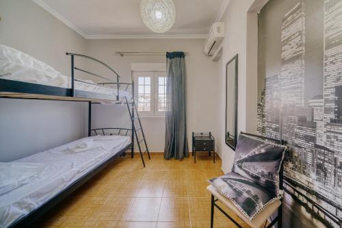 Un dormitorio con una litera y una silla. en Sofia's Apartment, en Chios