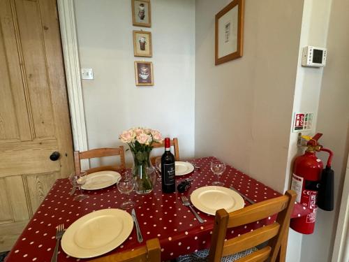a table with a red and white polka dot table cloth at Hargate Hall Self Catering in Buxton