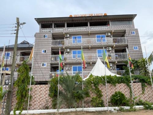 a building with flags in front of it at Sokea Safari Lodge And Suites in Kasoa