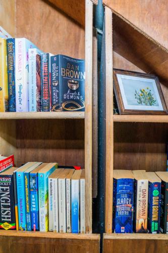 a book shelf filled with lots of books at Ohayo Siargao in General Luna