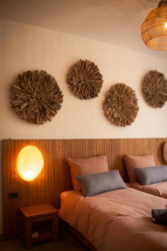 a bedroom with two beds and two lights on the wall at Résidence Alissa Charleroi Airport in Charleroi