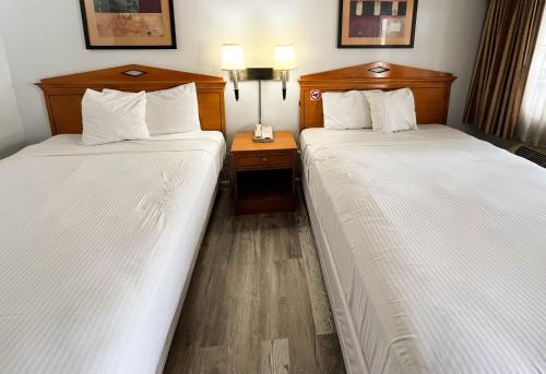 two beds sitting next to each other in a hotel room at Motel 6 San Francisco CA Lombard Street in San Francisco
