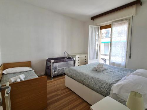 a bedroom with two beds and a window at Su e Giù Levante in Rapallo