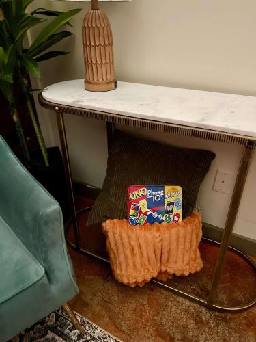 a table with two bags of snacks sitting under it at Beautifully Modern Townhouse in Historic SPR in Jacksonville