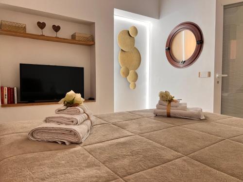 a bedroom with a large bed with a flat screen tv at Pompei Sunday Estate Exclusive Apartaments in Pompei