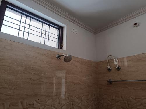 a bathroom with a shower and a window at The Wings Home Experience Peace & Coziness 1 BHK in Kakarmatha