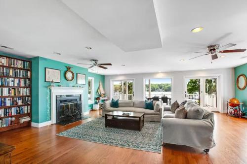 a living room with a couch and a fireplace at Oasis by the Bay - Waterfront Heated Pool Hot Tub in Annapolis
