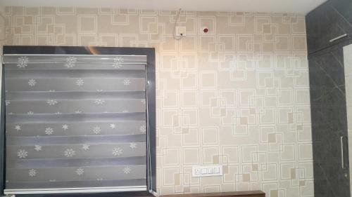 a metal garage door in a room with a wall at Vizag Venya Vihar a 2BHK Deluxe Furnished HomeStays in Visakhapatnam