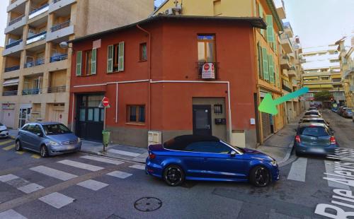 a blue car parked in front of a building at Central Super Loft in Nice