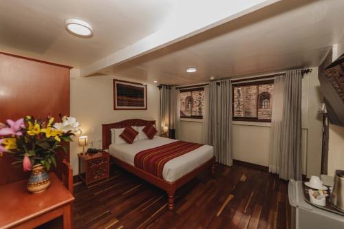a hotel room with a bed and a window at Quechua Hotel Cusco in Cusco
