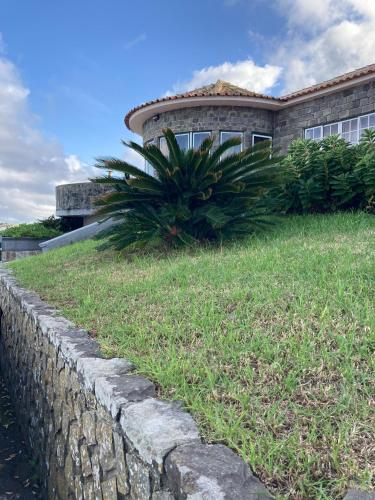 a retaining wall in front of a house at Casa Vista Mar in Porto Martins