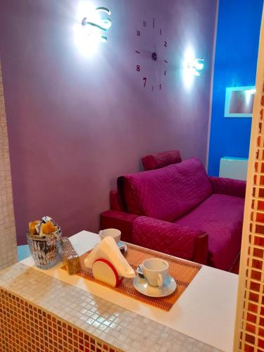 a living room with a red couch and a table at LA CASA DI CARTA red in Fiuggi