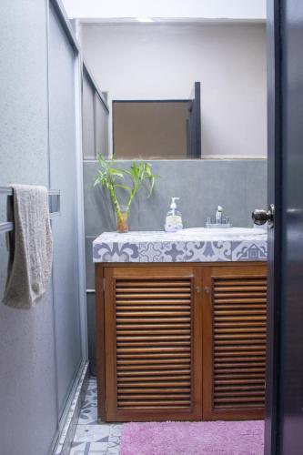 a bathroom with a sink and a mirror at Gutierrez Hostel in Lima