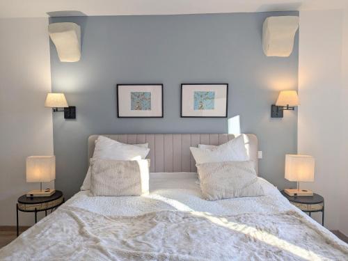 a bedroom with a large white bed with two lamps at Séjour ressourçant en Berry proche Zoo de Beauval - FR-1-591-732 in Saint-Cyran-du-Jambot