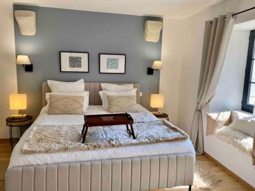 a bedroom with a large bed with a table on it at Séjour ressourçant en Berry proche Zoo de Beauval - FR-1-591-732 in Saint-Cyran-du-Jambot
