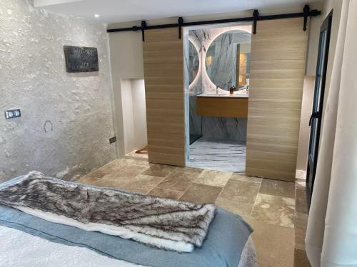 a bathroom with a shower with a large mirror at Séjour Historique au Domaine de Migny : Gîte avec Bain Nordique et Piscine - FR-1-591-731 in Saint-Cyran-du-Jambot