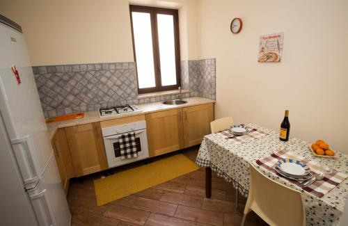 a kitchen with a table and a table and a window at Massimissimo in Palermo