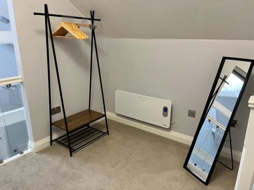 a dressing room with a mirror and a shelf at A Cozy Magical Retreat at Knightwood Oak, New Forest in Ower