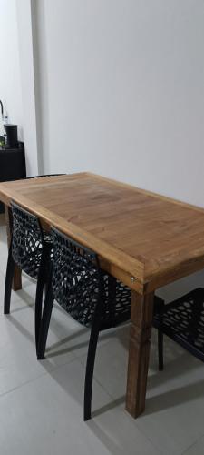 a wooden table with a bench around it at Moradas de Ibicuí - Apartamentos com vista para o mar in Mangaratiba