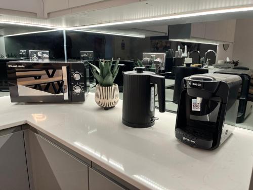 a coffee maker on a counter in a kitchen at A Cozy Magical Retreat at Knightwood Oak, New Forest in Ower