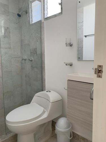 a bathroom with a toilet and a glass shower at Villa Zafiro in Cancún