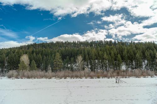 a person is flying a kite in a snow covered field at Orion Farmstead in Ovando