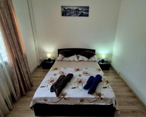 a bedroom with a bed with clothes on it at LAMAITEI RESIDENCE in Craiova