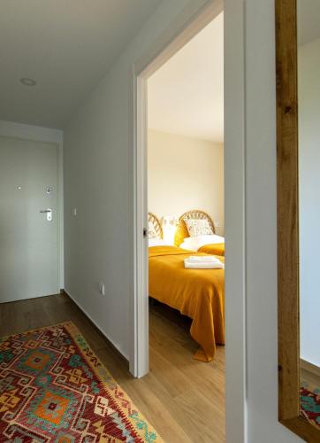 a bedroom with a bed with an orange bedspread at Casa Feliz - Santa Rosalia Life and Lake Resort in Torre-Pacheco