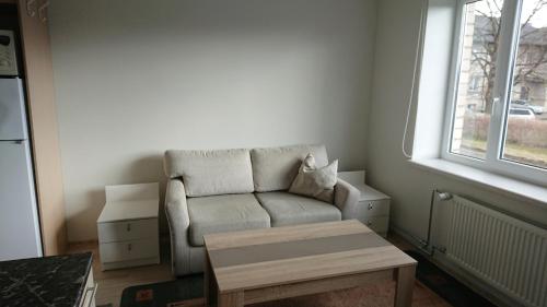 a small living room with a couch and a table at Tootsi Apartments in Tootsi