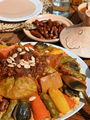 a plate of food with vegetables and beans on a table at Maison Kenoosha Boutique Hotel & Spa in Marrakech