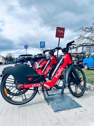 a red bike is parked next to a sign at Yellow Lotus in Gdańsk