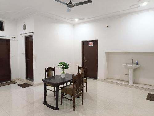 a dining room with a table and a sink at The Wings Home Your Home Away From Home 2 BHK in Kakarmatha