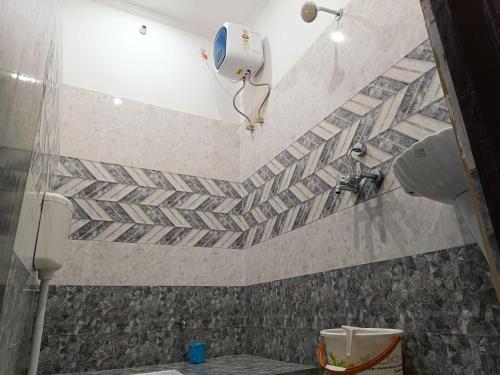 a bathroom with a shower and a toilet in it at The Wings Home Your Home Away From Home 2 BHK in Kakarmatha