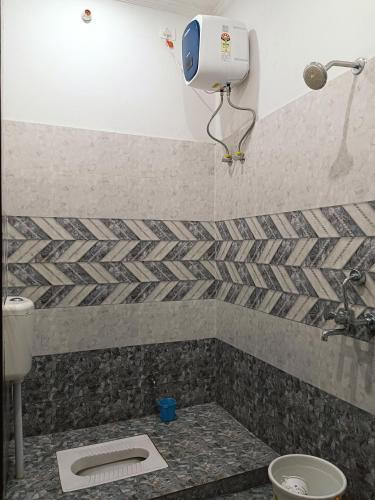 a bathroom with a toilet and a camera on the wall at The Wings Home Your Home Away From Home 2 BHK in Kakarmatha