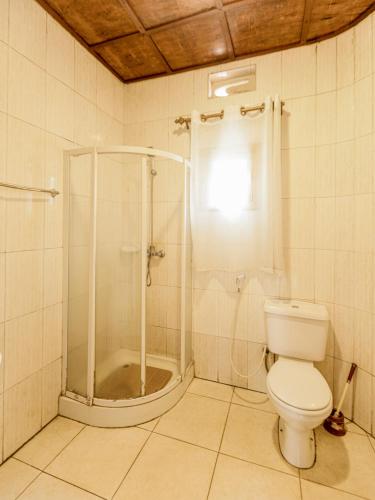a bathroom with a shower and a toilet at Hotel Saint jean Leopold Apartment in Kigali