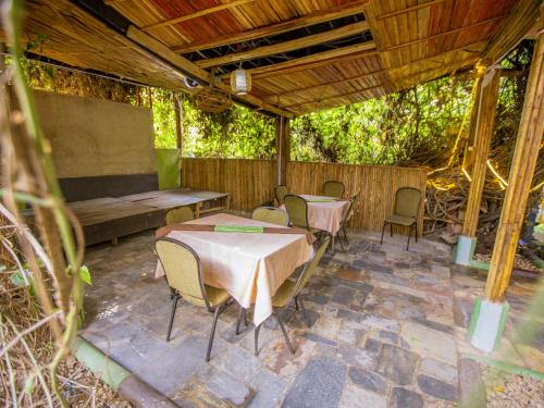 a patio with two tables and chairs and a bench at Hotel Saint jean Leopold Apartment in Kigali