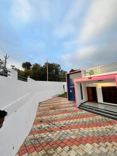 a building on top of a white wall at Enrich Tourist Homes in Agali