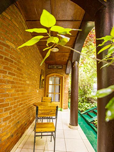 a table and a chair on a patio at Hotel Saint jean Leopold Apartment in Kigali